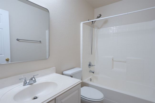 Full spare bath featuring vanity and washtub / shower combination | Image 28