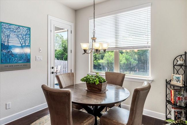 Dining room with dark wood finished floors and a textured wall | Image 14