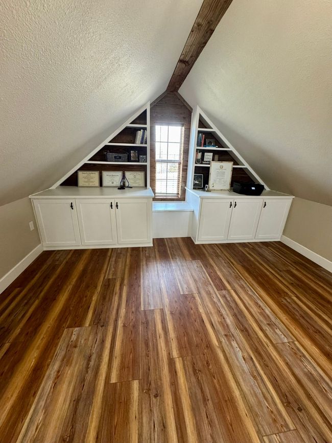 Additional living space with dark wood-style floors, baseboards, vaulted ceiling, and a textured ceiling | Image 20