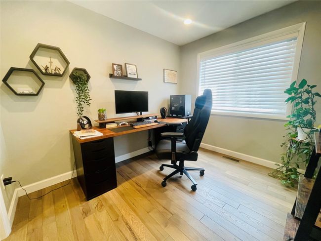 Office area with wood-type flooring, and visible vents | Image 18
