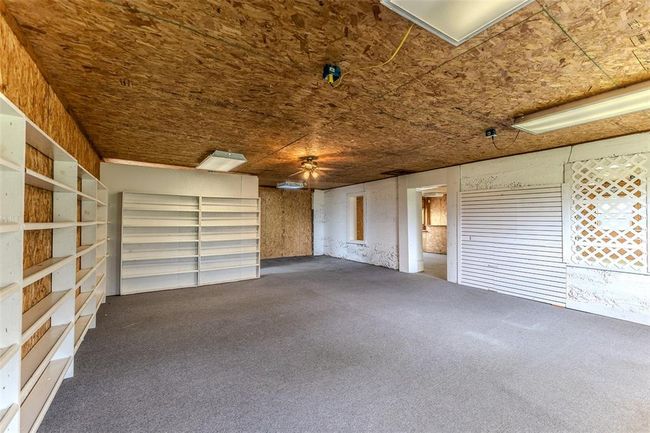 Garage featuring a ceiling fan | Image 51