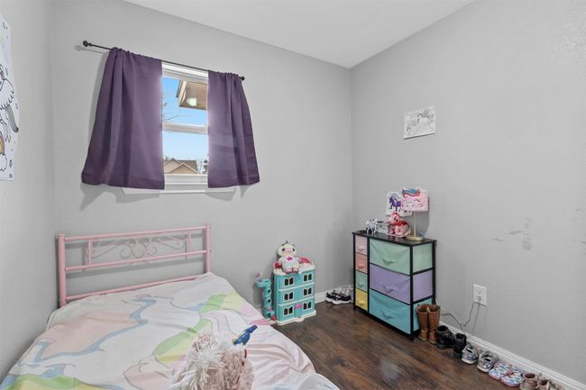 Bedroom with baseboards and wood finished floors | Image 24