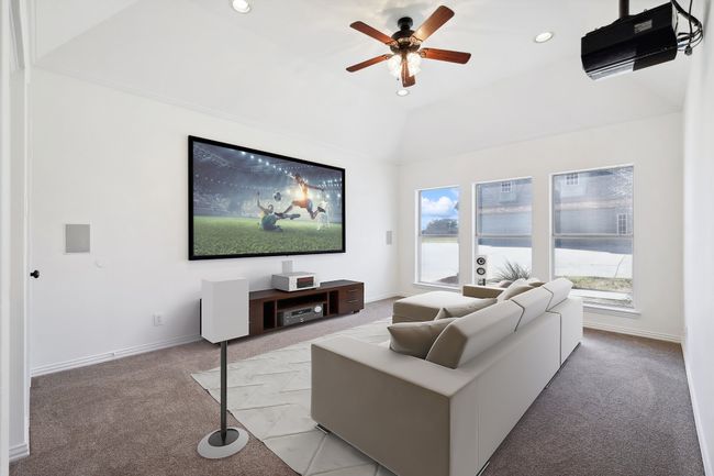 Living room with light carpet, recessed lighting, a ceiling fan, baseboards, and lofted ceiling | Image 18