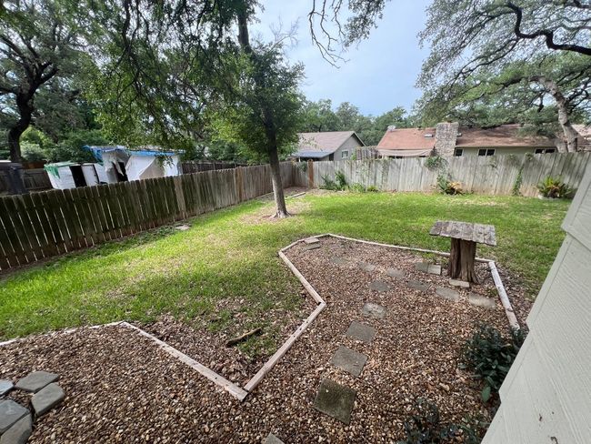 View of fenced backyard | Image 10