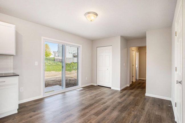There is a dedicated dining nook adjacent to the kitchen. Sliding doors lead to the rear yard which has a 10x10 patio – perfect for indoor/outdoor dining & entertaining. | Image 6