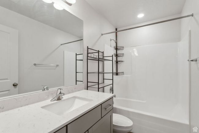 Bathroom with LVP floors, toilet, vanity, and shower / tub combination | Image 20
