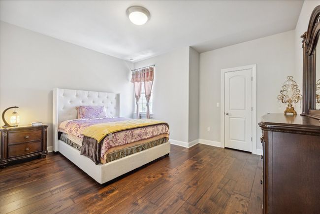 Bedroom featuring dark wood finished floors and baseboards | Image 27