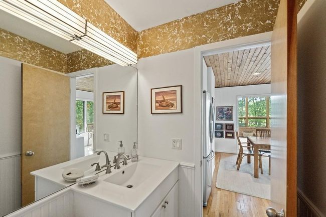 Bathroom with wood finished floors, vanity, and wood ceiling | Image 6