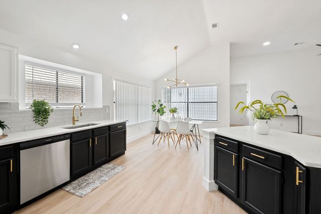 Kitchen featuring tasteful backsplash, dishwasher, and a sink | Image 16