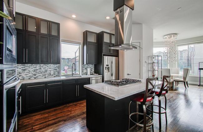 Granite countertops and with tons of cabinet space and storage in this fabulous kitchen! | Image 13