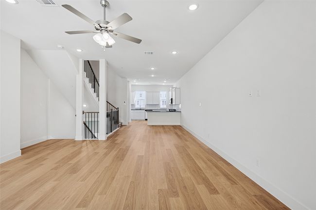 Unfurnished living room featuring ceiling fan and light wood-type flooring | Image 14