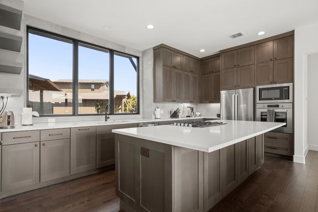 Island provides additional breakfast bar for casual dining option. | Image 7