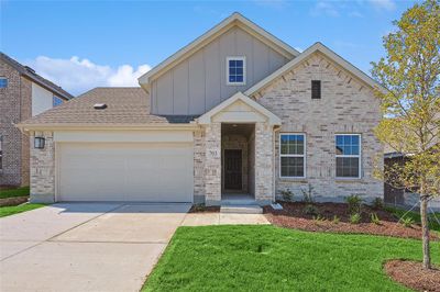 View of front of house with a garage and a front lawn | Image 1