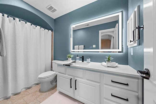 All secondary bathrooms present custom marble countertops, mirrors and cabinet hardware to complete the luxury look. | Image 25