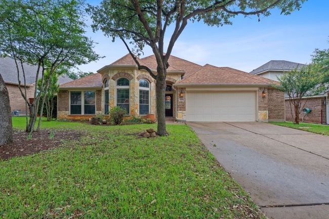 View of front of property featuring an attached garage, concrete driveway | Image 22