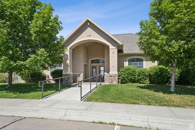 View of front facade featuring stucco siding, french doors, stone siding, a gate, and roof with shingles | Image 26
