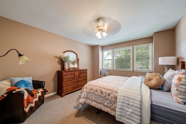 Bedroom featuring light carpet and a ceiling fan | Image 23