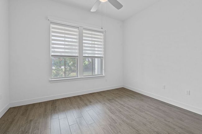 One of two secondary bedrooms nestled away in their own hallway off the entryway. | Image 25