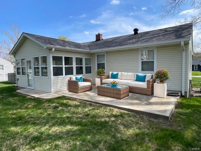 Rear view of house with an outdoor hangout area, a chimney, a patio area, a shingled roof, and a yard | Image 14
