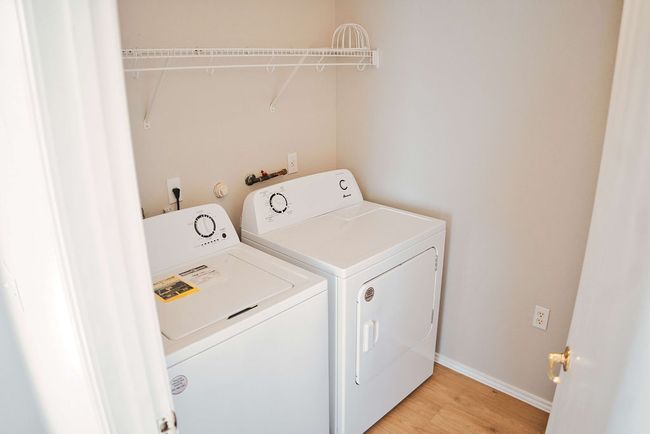 Washroom featuring washer and clothes dryer and light wood-type flooring | Image 14