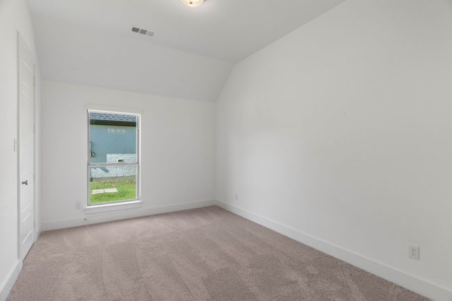 Carpeted spare room with baseboards and vaulted ceiling | Image 11