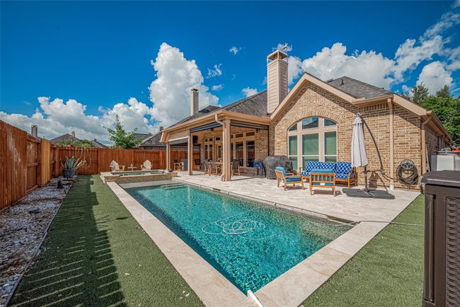 Chlorine Pool is surrounded by astroturf. Astroturf offers a low-maintenance, green year-round solution that eliminates the need for mowing, watering, or fertilizing. | Image 32