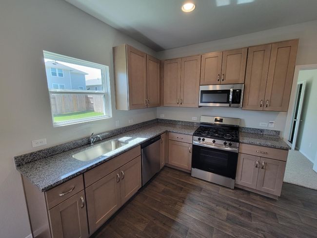 Kitchen featuring appliances with stainless steel finishes, dark wood finished floors, and recessed lighting | Image 10