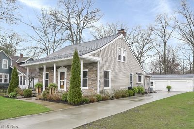 View of front facade with a front lawn and a garage | Image 3