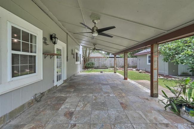Expansive covered porch to enjoy even on those few days it is hot here in Texas. The fans keep the breeze blowing and the sun off of you and your windows, helping for all around cooling. | Image 34