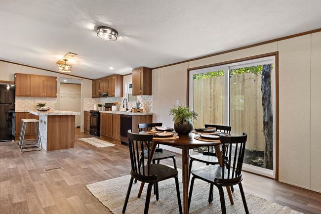 Dining room with light wood-style flooring, visible vents, and ornamental molding | Image 21