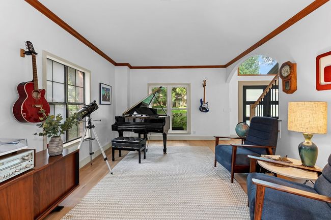 Living area featuring ornamental molding and light wood-style floors | Image 20