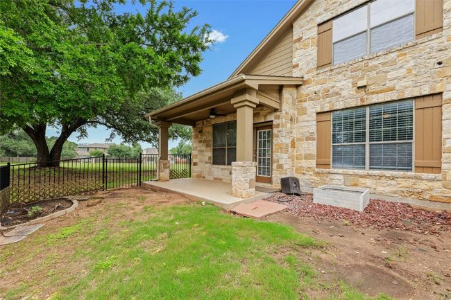 View of yard featuring ceiling fan and a patio area | Image 24