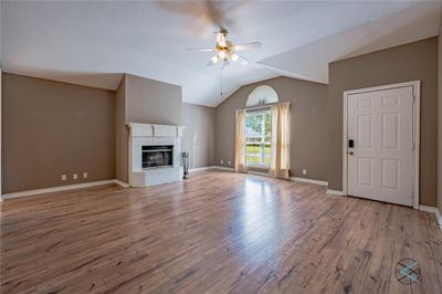 Living room with ceiling fan, lofted ceiling, and hardwood / wood-style floors | Image 1