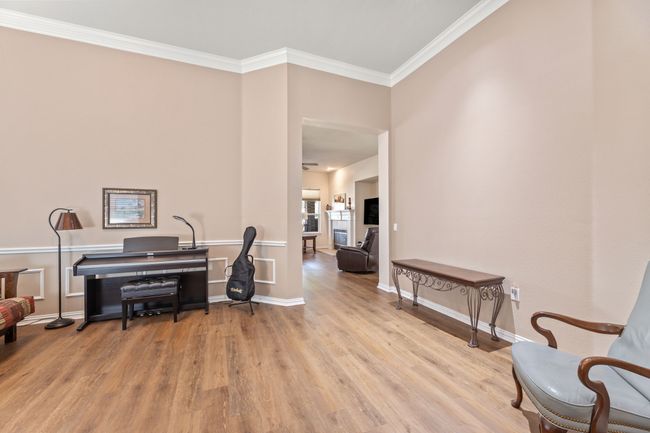 Office area with wood finished floors, ornamental molding, and baseboards | Image 6