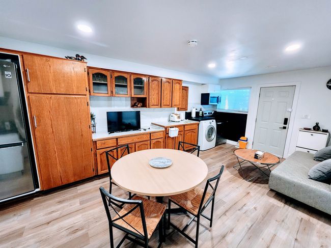 Dining area featuring washer / dryer, light wood-style floors, and recessed lighting | Image 33