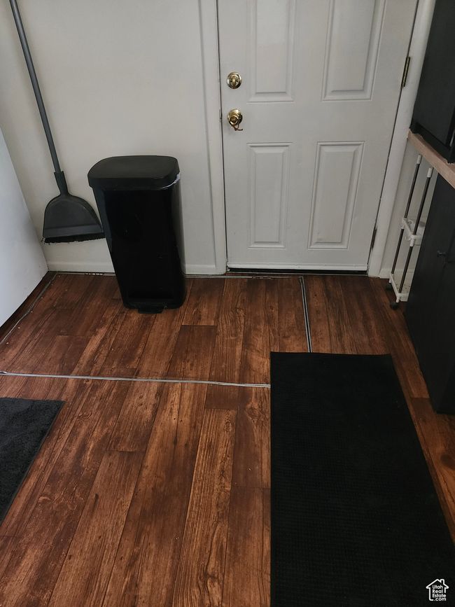 Detailed view of vinyl kitchen flooring and basement access | Image 6