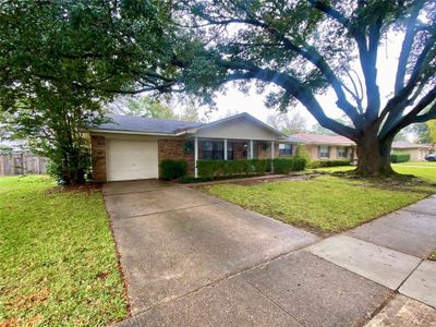 Single story home featuring a garage and a front yard | Image 2