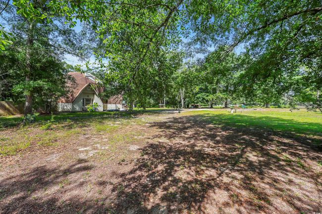 View of yard with view of wooded area | Image 16