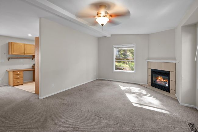Unfurnished living room with a nice fireplace, and a ceiling fan | Image 8