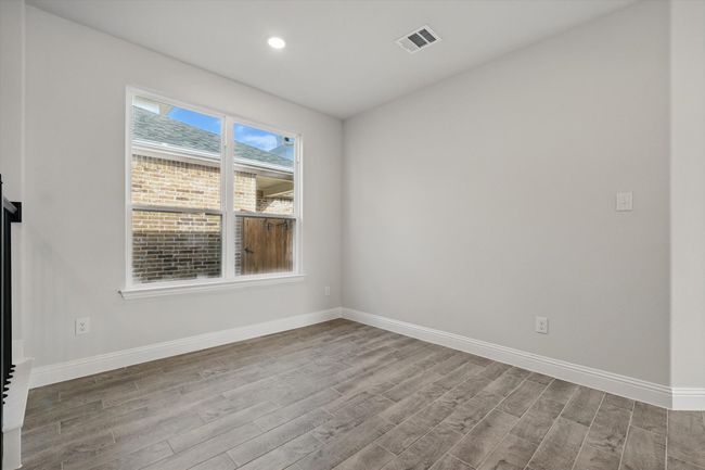 Spare room with baseboards, visible vents, wood finished floors, and recessed lighting | Image 8