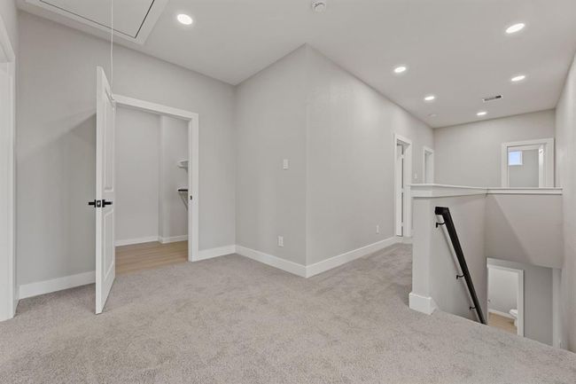 Welcome to the 2nd floor — where convenience meets comfort. This spacious landing leads to the utility room and primary suite, offering easy access to your home’s essential spaces. With plenty of natural light and a well-designed layout, this area provides the perfect balance of function and style. | Image 10