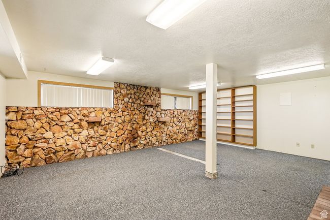 Finished basement with a textured ceiling and carpet flooring | Image 29