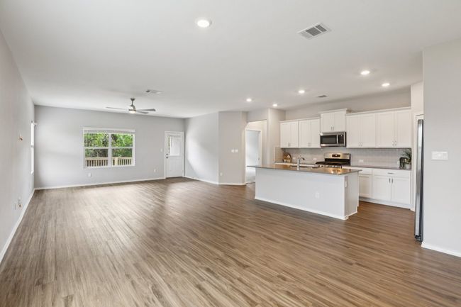 Open floor plan with a spacious kitchen overlooking the large living and dining areas. | Image 4