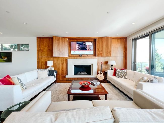 Living area featuring plenty of natural light, recessed lighting, a fireplace with raised hearth, and light wood-style floors | Image 8