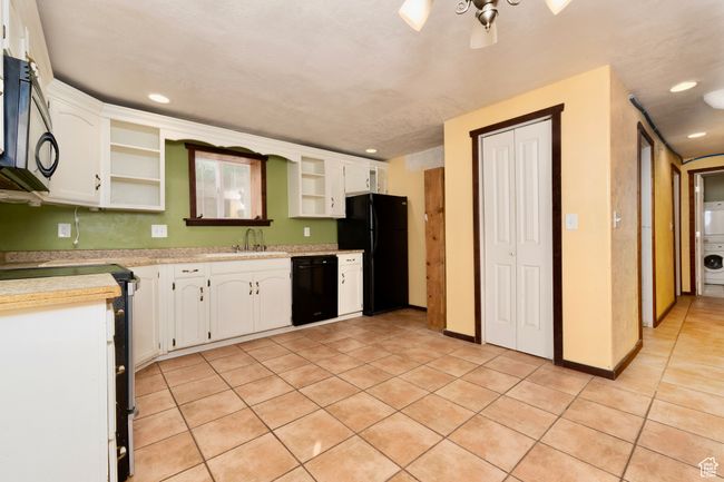 Kitchen featuring open shelves, black appliances, light tile patterned flooring, white cabinets, and recessed lighting | Image 29