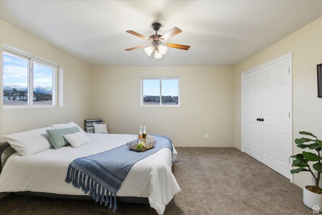 Bedroom with a closet, carpet flooring, and a ceiling fan | Image 13