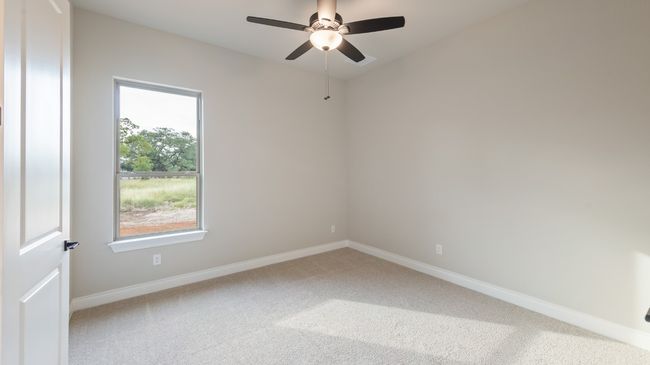 Unfurnished room with light colored carpet and ceiling fan | Image 35