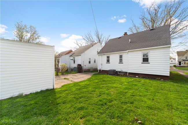 Back of property featuring a lawn, roof with shingles, central AC unit, and a patio | Image 29
