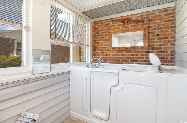 Bathroom featuring brick wall | Image 14