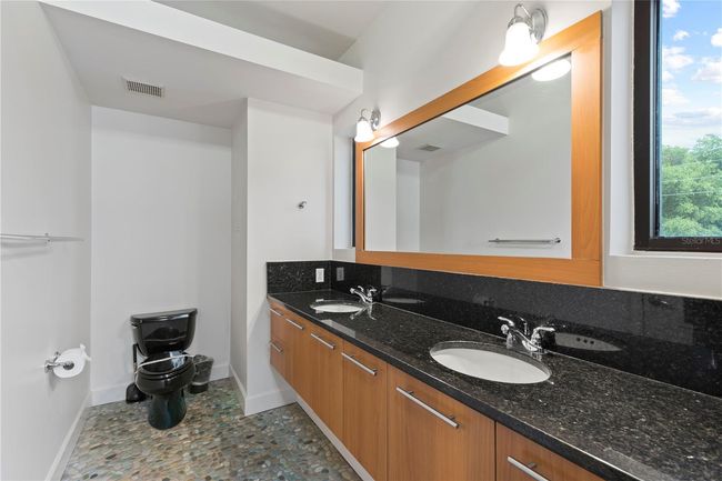 MASTER BATHROOM WITH EXQUISITE CONCRETE FLOORING WITH WINDOWS FACING EAST | Image 14